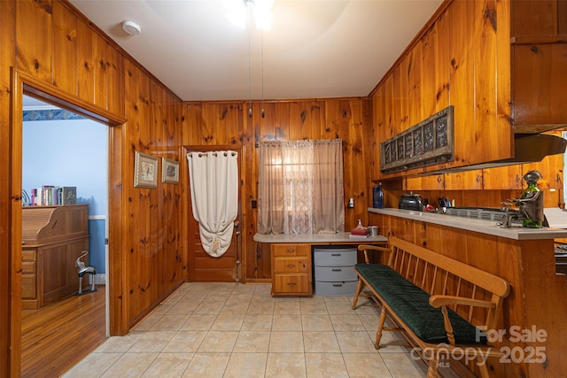 100 S Rudisill Ave, Cherryville, NC 28021 - kitchen featuring brown cabinets, light countertops, and wooden walls