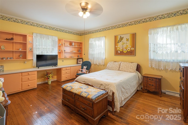 100 S Rudisill Ave, Cherryville, NC 28021 - bedroom with baseboard heating, wood-type flooring, and ceiling fan