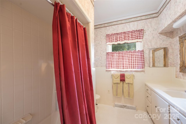 100 S Rudisill Ave, Cherryville, NC 28021 - bathroom with toilet, tile walls, vanity, wallpapered walls, and wainscoting
