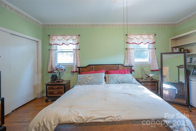 100 S Rudisill Ave, Cherryville, NC 28021 - bedroom featuring multiple windows, wood finished floors, crown molding, and a closet