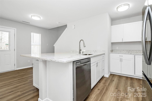 7214 Fox Point Dr, Charlotte, NC 28269 - kitchen featuring appliances with stainless steel finishes, a peninsula, a sink, dark wood-style floors, and white cabinets