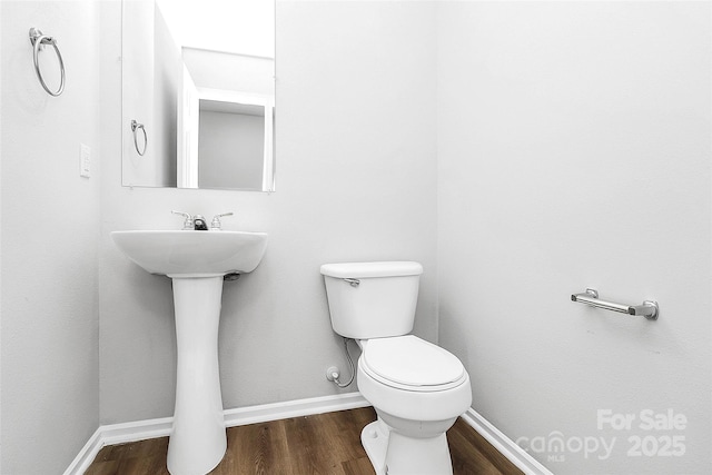 7214 Fox Point Dr, Charlotte, NC 28269 - bathroom with wood finished floors, toilet, baseboards, and a sink
