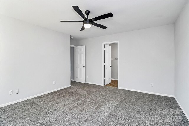 7214 Fox Point Dr, Charlotte, NC 28269 - unfurnished bedroom with dark colored carpet, baseboards, and a ceiling fan