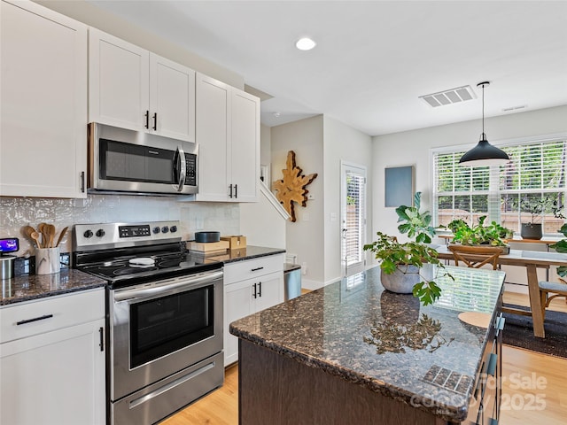 218 Water Leaf Dr, Weaverville, NC 28787 - kitchen featuring appliances with stainless steel finishes, white cabinetry, tasteful backsplash, dark stone counters, and recessed lighting