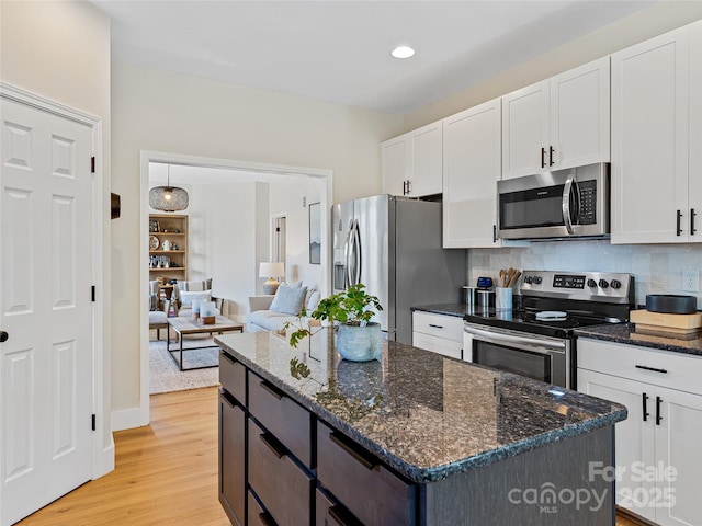 218 Water Leaf Dr, Weaverville, NC 28787 - kitchen with appliances with stainless steel finishes, white cabinetry, light wood-style floors, backsplash, and recessed lighting