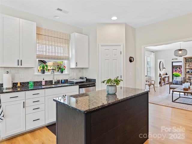 218 Water Leaf Dr, Weaverville, NC 28787 - kitchen with a sink, dishwasher, light wood-style floors, white cabinetry, and dark stone countertops