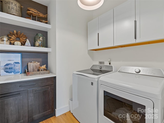 218 Water Leaf Dr, Weaverville, NC 28787 - washroom featuring cabinet space, independent washer and dryer, light wood finished floors, and baseboards