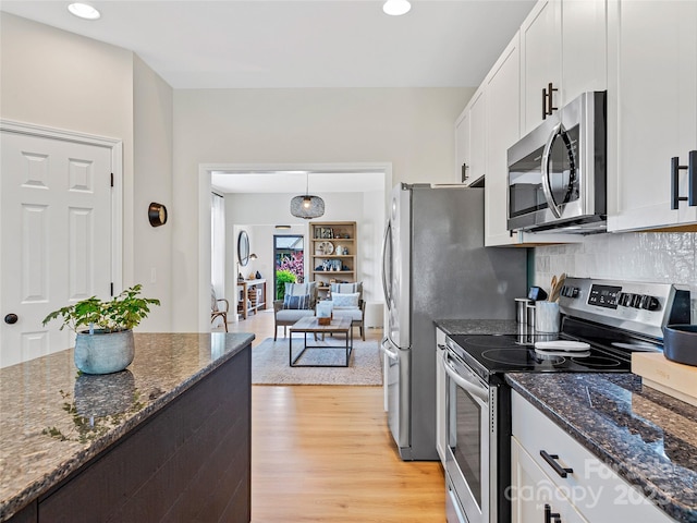 218 Water Leaf Dr, Weaverville, NC 28787 - kitchen with stainless steel appliances, white cabinetry, light wood finished floors, decorative backsplash, and recessed lighting