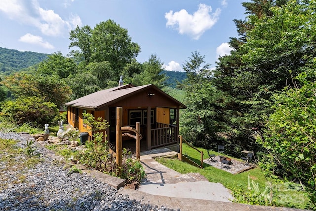 139 Ivy Ridge Church Rd, Mars Hill, NC 28754 - rustic home with an outdoor fire pit, a porch, a wooded view, and a mountain view