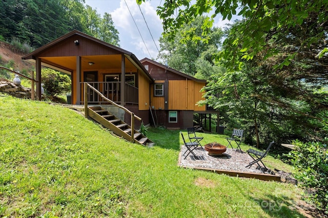 139 Ivy Ridge Church Rd, Mars Hill, NC 28754 - back of house featuring a fire pit, stairway, and a lawn