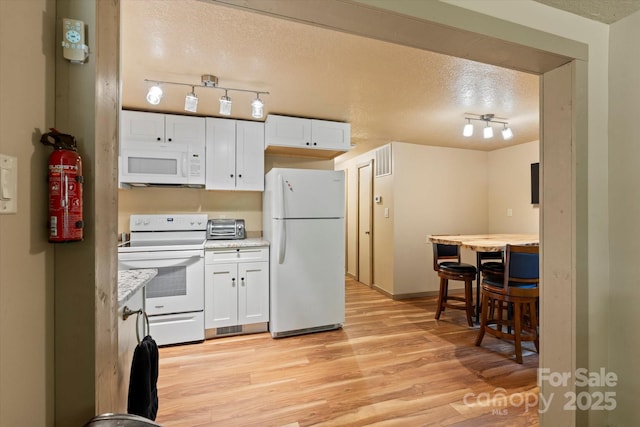 139 Ivy Ridge Church Rd, Mars Hill, NC 28754 - kitchen with white appliances, rail lighting, white cabinetry, light countertops, and a textured ceiling