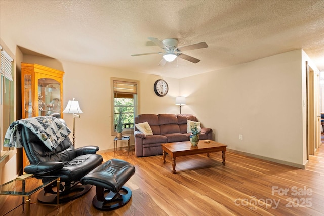 139 Ivy Ridge Church Rd, Mars Hill, NC 28754 - living room with a textured ceiling, a ceiling fan, and light wood-style flooring