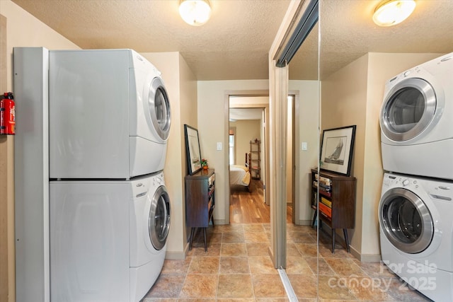 139 Ivy Ridge Church Rd, Mars Hill, NC 28754 - laundry room featuring stacked washer and clothes dryer and a textured ceiling