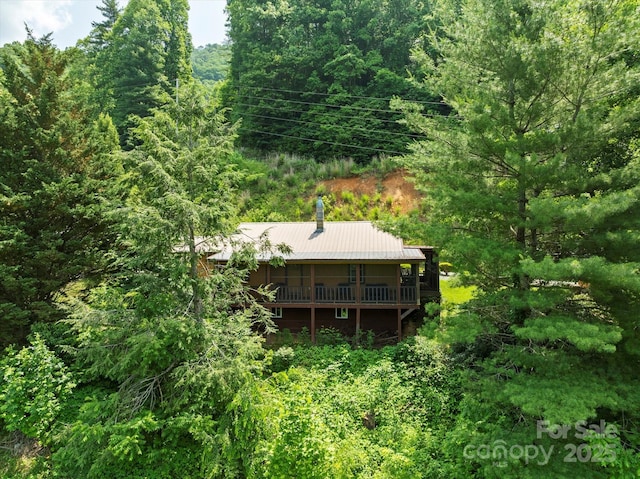 139 Ivy Ridge Church Rd, Mars Hill, NC 28754 - back of property featuring a forest view, a metal roof, and a wooden deck