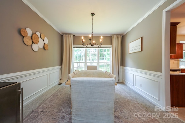 2908 Barnard Castle Ln, Matthews, NC 28104 - carpeted dining area featuring a decorative wall, a chandelier, wainscoting, and ornamental molding