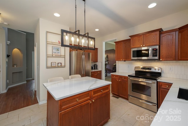 2908 Barnard Castle Ln, Matthews, NC 28104 - kitchen featuring appliances with stainless steel finishes, decorative backsplash, decorative light fixtures, recessed lighting, and light stone counters