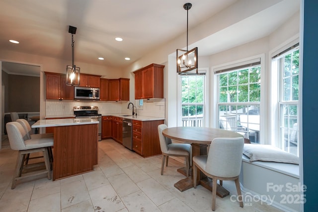 2908 Barnard Castle Ln, Matthews, NC 28104 - kitchen featuring stainless steel appliances, a sink, tasteful backsplash, light countertops, and recessed lighting