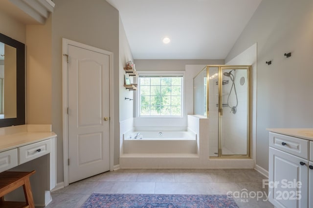 2908 Barnard Castle Ln, Matthews, NC 28104 - bathroom with vanity, a stall shower, a bath, vaulted ceiling, and baseboards