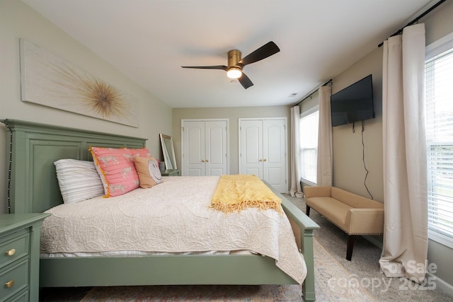 2908 Barnard Castle Ln, Matthews, NC 28104 - carpeted bedroom with two closets, multiple windows, and ceiling fan