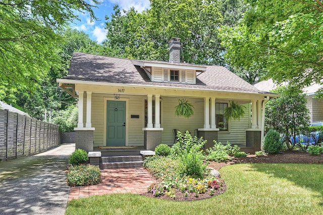 1417 The Plz, Charlotte, NC 28205 - bungalow-style home featuring a chimney, a porch, and a shingled roof