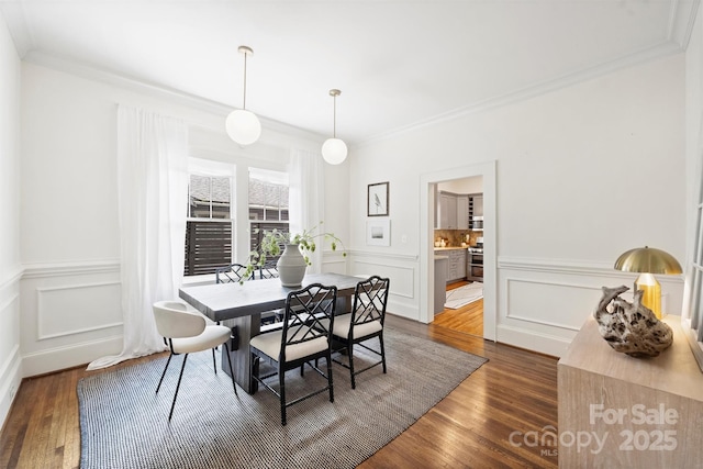 1417 The Plz, Charlotte, NC 28205 - dining space with crown molding, a decorative wall, dark wood-style flooring, and a wainscoted wall