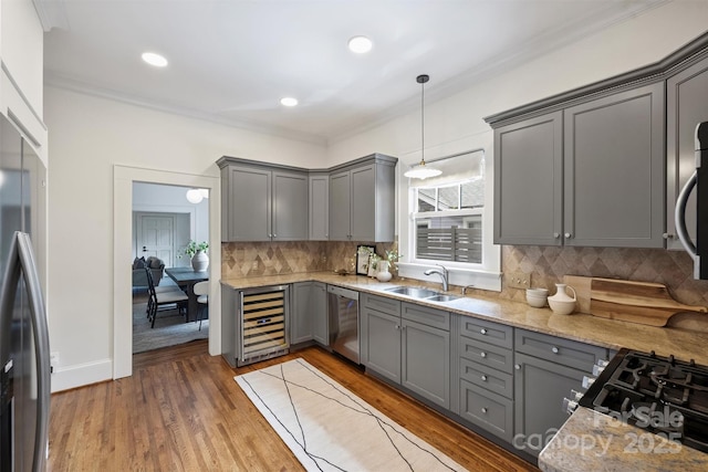 1417 The Plz, Charlotte, NC 28205 - kitchen with gray cabinets, appliances with stainless steel finishes, crown molding, beverage cooler, and tasteful backsplash