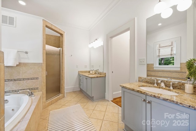 1417 The Plz, Charlotte, NC 28205 - bathroom featuring a stall shower, ornamental molding, two vanities, a jetted tub, and tile patterned flooring