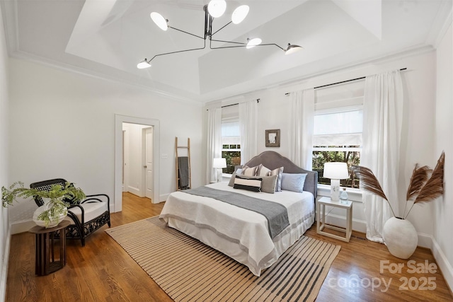 1417 The Plz, Charlotte, NC 28205 - bedroom with a chandelier, wood finished floors, a raised ceiling, and crown molding