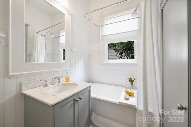 1417 The Plz, Charlotte, NC 28205 - bathroom featuring wainscoting, a freestanding bath, and vanity