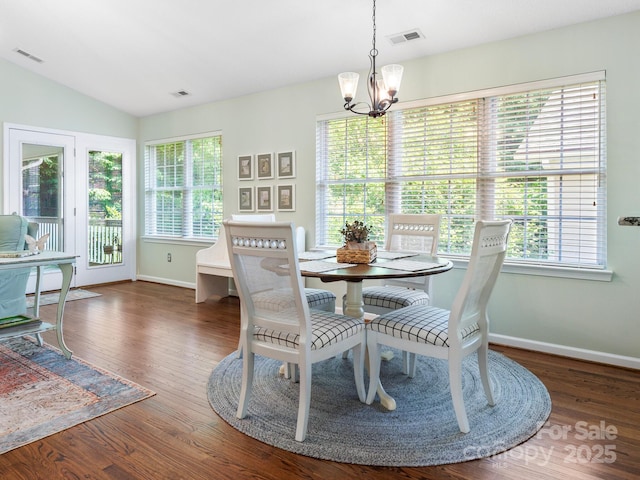 20 E Fairway View Ct, Etowah, NC 28729 - dining area with a chandelier, healthy amount of natural light, wood finished floors, and vaulted ceiling