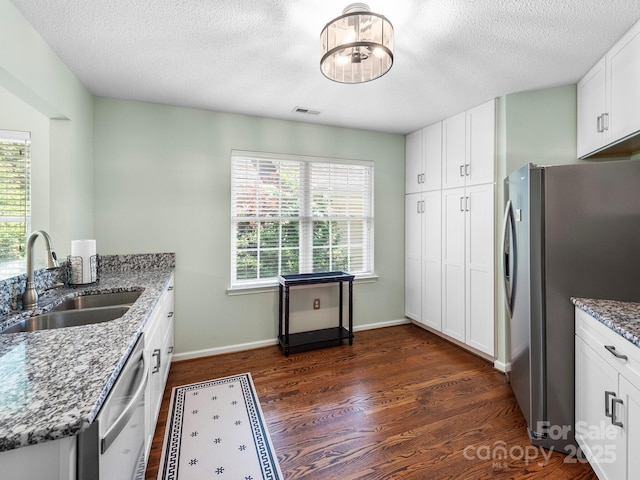 20 E Fairway View Ct, Etowah, NC 28729 - kitchen featuring appliances with stainless steel finishes, light stone counters, dark wood finished floors, white cabinetry, and a textured ceiling