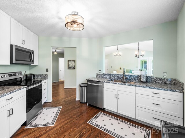 20 E Fairway View Ct, Etowah, NC 28729 - kitchen featuring stainless steel appliances, a chandelier, white cabinets, dark wood-style floors, and stone counters