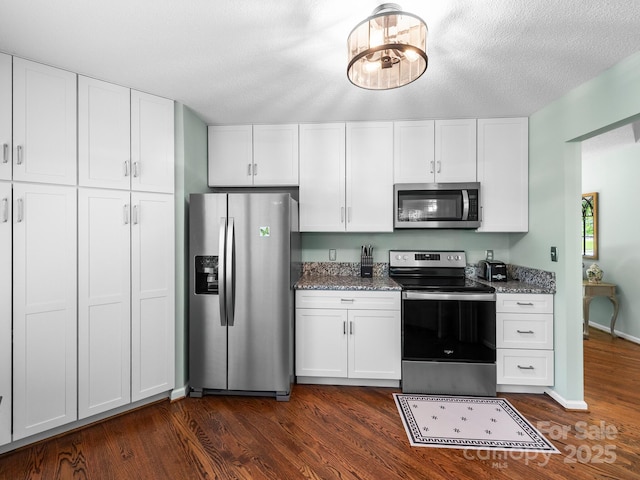 20 E Fairway View Ct, Etowah, NC 28729 - kitchen with appliances with stainless steel finishes, dark wood-style floors, light stone counters, and white cabinetry