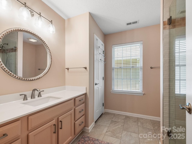 20 E Fairway View Ct, Etowah, NC 28729 - bathroom featuring vanity, a tile shower, marble look tile flooring, and a textured ceiling