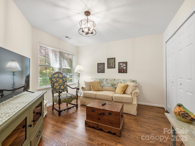 20 E Fairway View Ct, Etowah, NC 28729 - living room with dark wood-style floors, a chandelier, and a textured ceiling