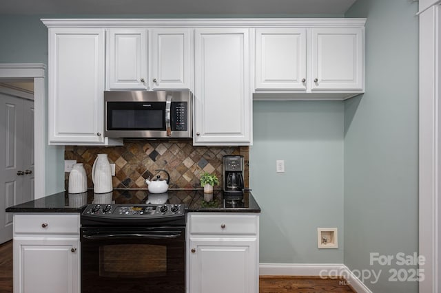 506 Academy St, Mcadenville, NC 28101 - kitchen with black range with electric stovetop, stainless steel microwave, tasteful backsplash, and white cabinets