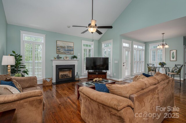 506 Academy St, Mcadenville, NC 28101 - living room featuring a chandelier, lofted ceiling, a glass covered fireplace, wood finished floors, and ceiling fan