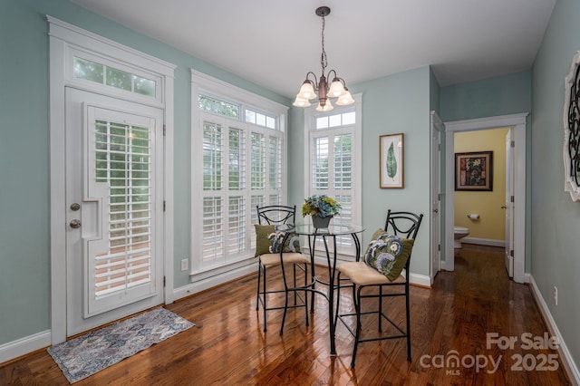 506 Academy St, Mcadenville, NC 28101 - dining room featuring a chandelier, dark wood-type flooring, and baseboards