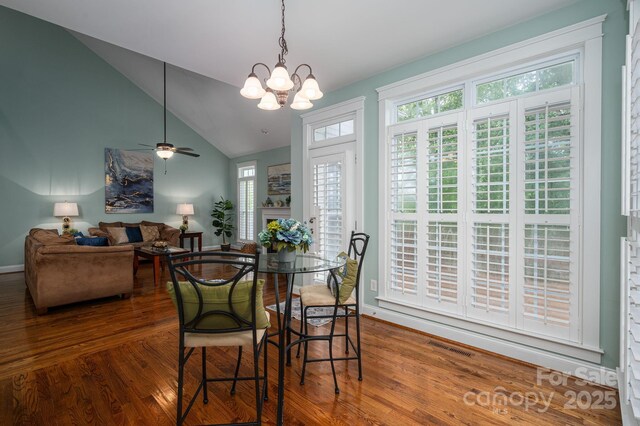 506 Academy St, Mcadenville, NC 28101 - dining space with wood finished floors, lofted ceiling, a chandelier, baseboards, and ceiling fan