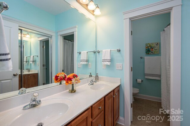 506 Academy St, Mcadenville, NC 28101 - full bath featuring toilet, double vanity, tile patterned flooring, and baseboards