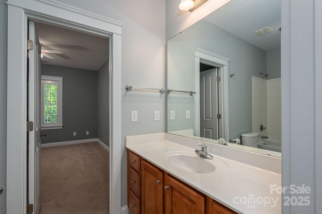 506 Academy St, Mcadenville, NC 28101 - bathroom featuring vanity, shower / tub combination, baseboards, toilet, and ceiling fan