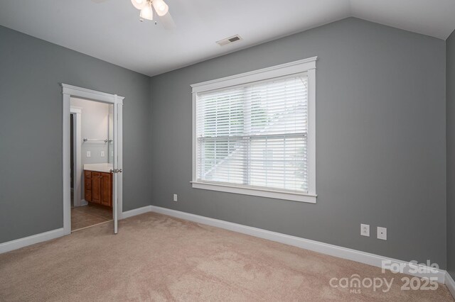 506 Academy St, Mcadenville, NC 28101 - unfurnished bedroom with light carpet, baseboards, ensuite bath, a ceiling fan, and lofted ceiling