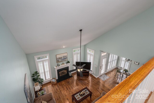 506 Academy St, Mcadenville, NC 28101 - living room with wood finished floors, lofted ceiling, a fireplace with flush hearth, and baseboards