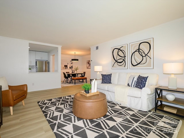 4754 Hedgemore Dr Unit E, Charlotte, NC 28209 - living area featuring light wood-style floors and ornamental molding
