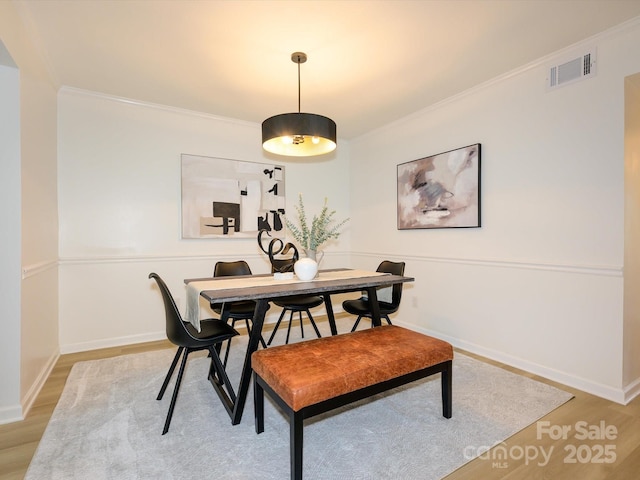 4754 Hedgemore Dr Unit E, Charlotte, NC 28209 - dining area featuring light wood-style flooring and crown molding