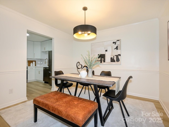 4754 Hedgemore Dr Unit E, Charlotte, NC 28209 - dining space featuring ornamental molding and light wood-style flooring