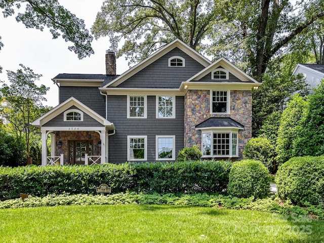 2526 Sherwood Ave, Charlotte, NC 28207 - view of front facade featuring stone siding, a chimney, and a front yard