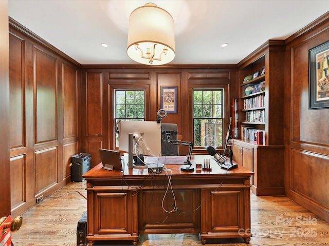 2526 Sherwood Ave, Charlotte, NC 28207 - home office featuring light wood-style floors, a decorative wall, ornamental molding, built in features, and wooden walls