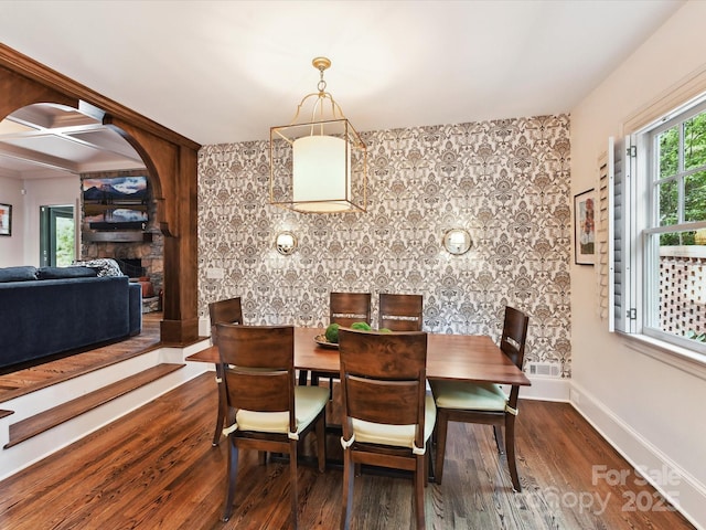 2526 Sherwood Ave, Charlotte, NC 28207 - dining space with wood finished floors, baseboards, a fireplace, and a ceiling fan