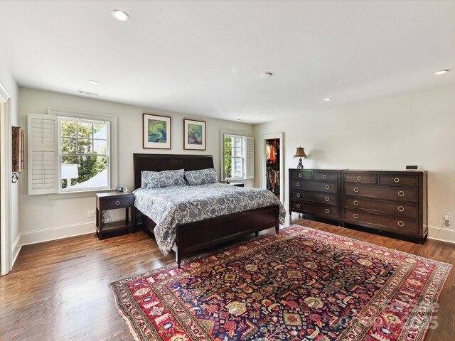 2526 Sherwood Ave, Charlotte, NC 28207 - bedroom featuring baseboards, wood finished floors, a walk in closet, and recessed lighting